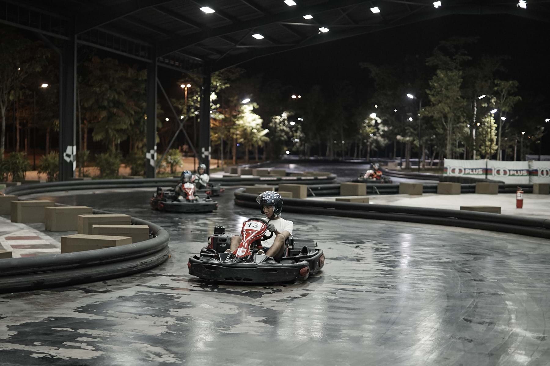 A group of people driving go-karts

Description automatically generated