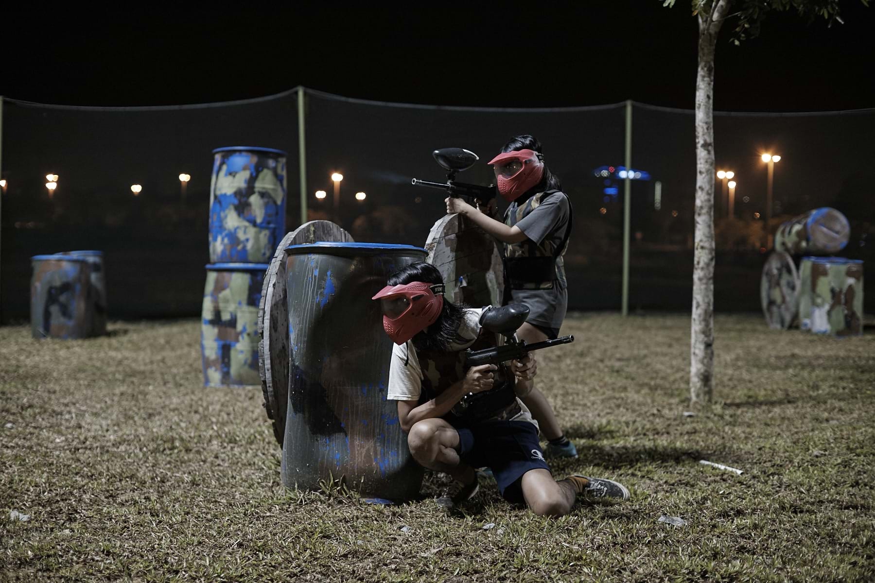 People playing paintball at night

Description automatically generated