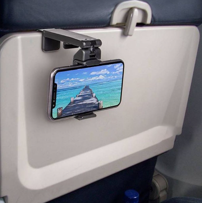 A cell phone attached to a holder on a seat

Description automatically generated